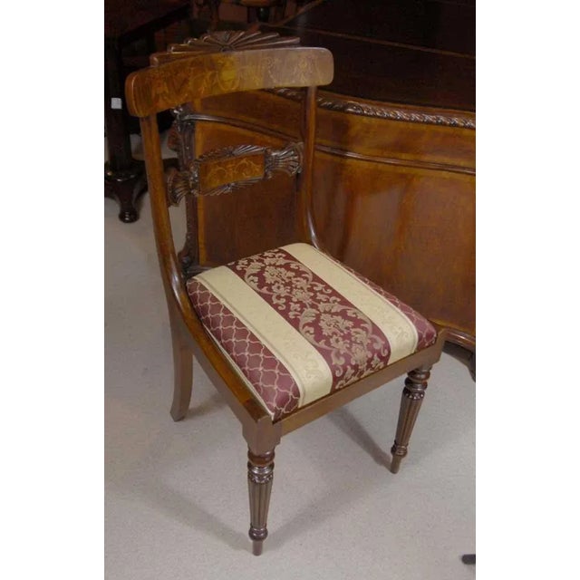 Absolutely amazing set of twelve English Regency style dining chairs. The set consists of ten side chairs and two arm...
