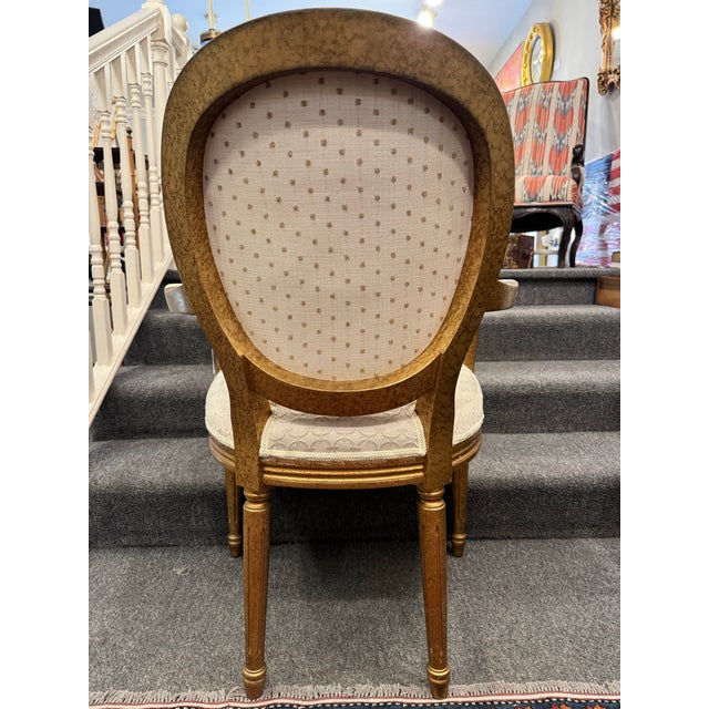 This is a vintage French Louis XVI style side chair. The wood is hand painted a gold tone. It has been newly reupholstered...