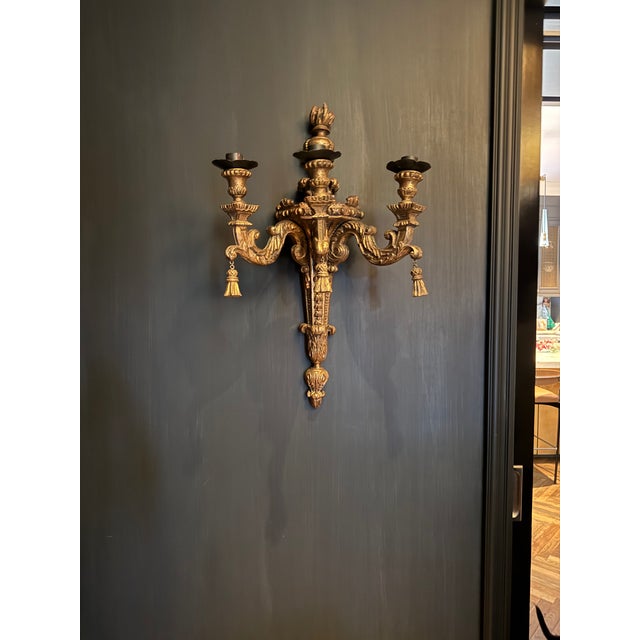 Antique Large scale carved gilded wall sconces, they have three arms each. wood tassels, these are a rare and unique find....