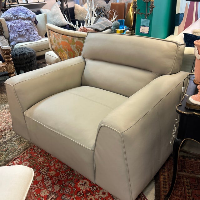 Gorgeous extra wide sumptuous gray leather swivel arm chair. The leather is ultra soft and smooth and the chair swivels...