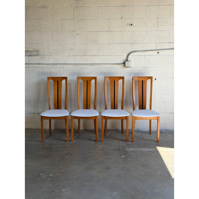 This set of four dining chairs features sculpted high backrests with clean Scandinavian lines. Vintage 1980s. Crafted in...