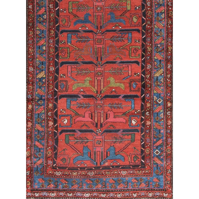 The rusty red field displays pairs of "horses" in grass green,royal blue and brick red. The horses are actually forked fat...