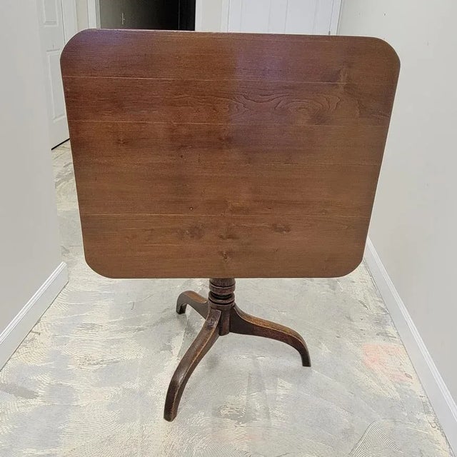 This charming and well-proportioned Georgian walnut tilt top table features rectangular top with rounded corners supported...