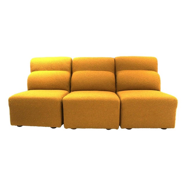 This set of three modular armchairs was produced in Italy in the 1970s and is upholstered in mustard-colored wool fabric....