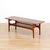 This Mid Century coffee table was designed and manufactured during 1960s. The table has teak construction with a...