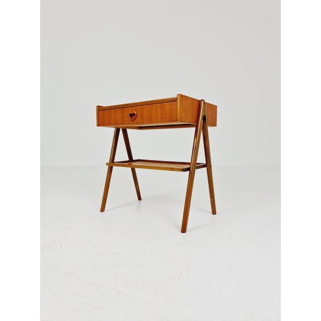 Mid-century teak rattan vintage side table/bedside table/nightstand straight from the sixties with rattan shelf. Usable as...