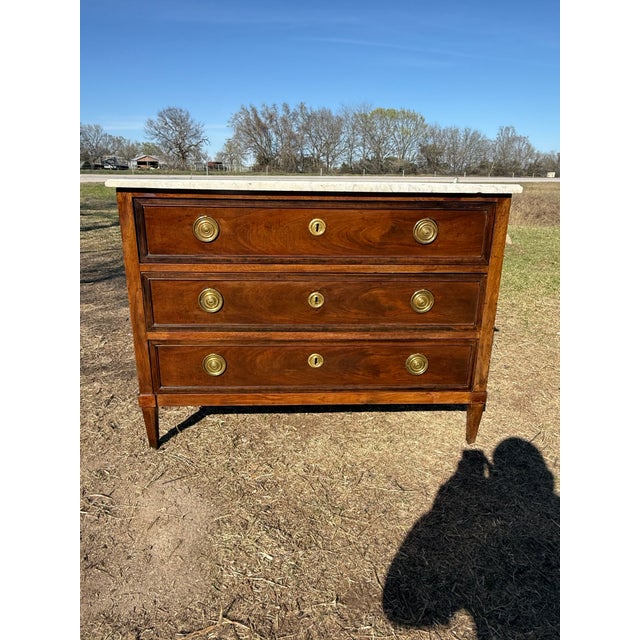 18th Century French Louis XVI Commode from France. Made of solid mahogany, with a Carrara marble top, the wood has been...