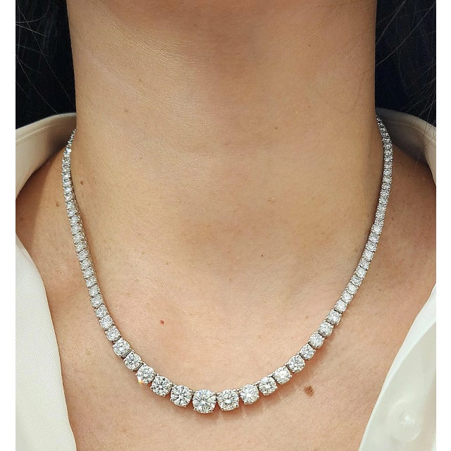 This elegant tennis necklace showcases a breathtaking array of 113 round-cut white diamonds, totaling 17.72 carats. Each...