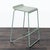 This Blu Dot counter stool features a sleek, modern design with a light green metal frame and a gently curved seat for...