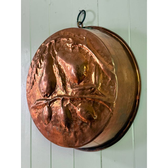 Very large vintage decorative hammered copper mold featuring branches with pears and peaches in relief. The round form,...