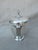 This is a silver plated ice bucket with a lid. This is perfect for a bar or a buffet. This could even be used to hold a...