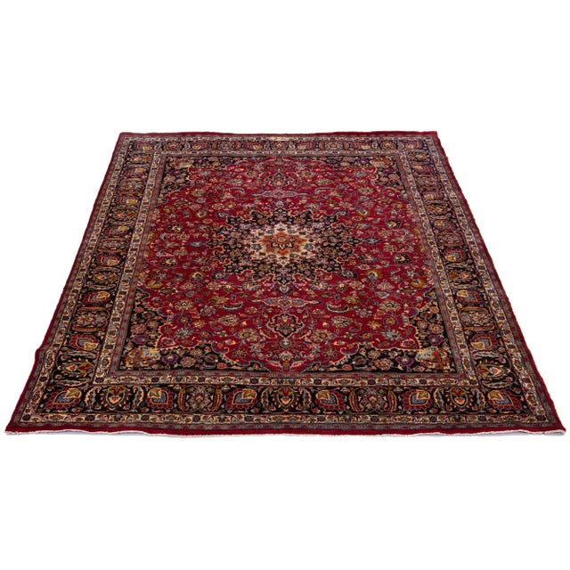 Vintage Handmade Mashad wool rug with multicolor allover motif and red field. This rug measures: 9'9" x 12'9"