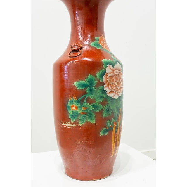 Chinese porcelain vase with cylindrical body and narrow mouth trumpet-shaped with two handles embossed on each side....