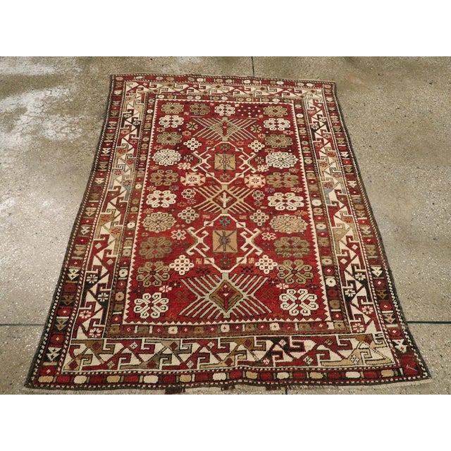 This Early 20th century Caucasian Kuba rug, measuring 3' 9" x 5' 2", embodies the spirited artistry of the Eastern...