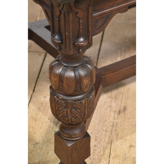 Oak Dining Table of generous proportions. The well-figured top has pull-out ends to incorporate two original oak leaves to...