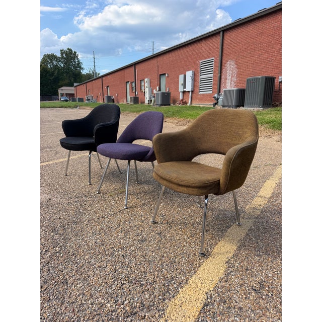 Offered as a set of three original 1970s Knoll International armchairs, featuring beautifully sculpted upholstered shells...