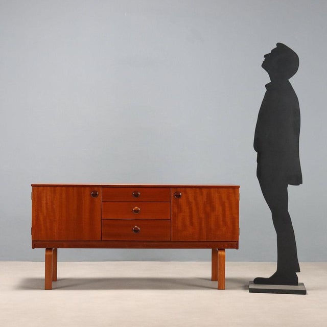 Vintage sideboard made of teak wood and perfectly restored in our workshops with two hinged doors and three central...