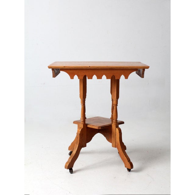 This Victorian side table dates to the late 19th century and reflects the quiet utility of the period. The rectangular top...