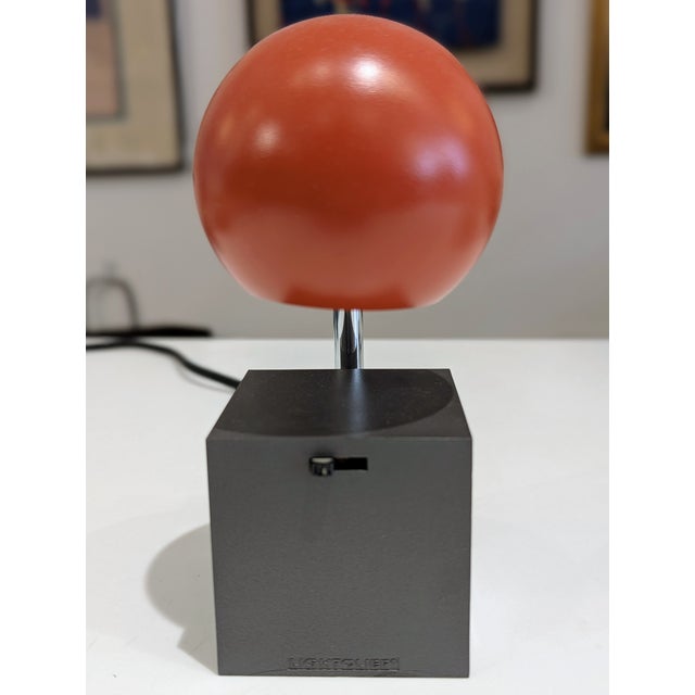 Vintage telescopic desk lamp by Lightolier featuring a spherical enameled steel shade in persimmon, chrome-plated...