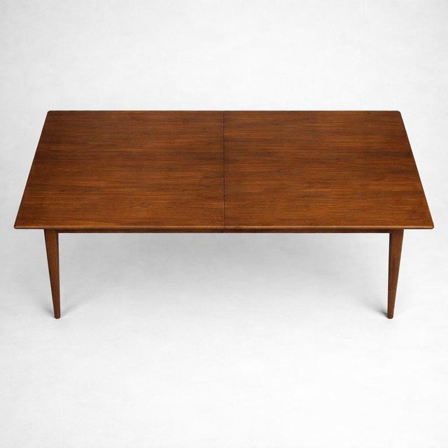 A refined mid-century teak dining table by Gordon Russell of Broadway, showcasing the maker’s renowned craftsmanship and...