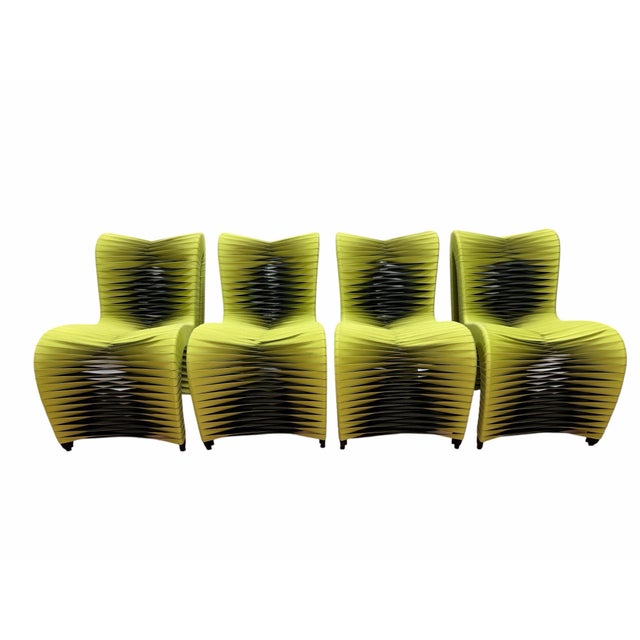 Make a bold statement with this striking set of four Seat Belt Dining Chairs from the Phillips Collection, designed by...