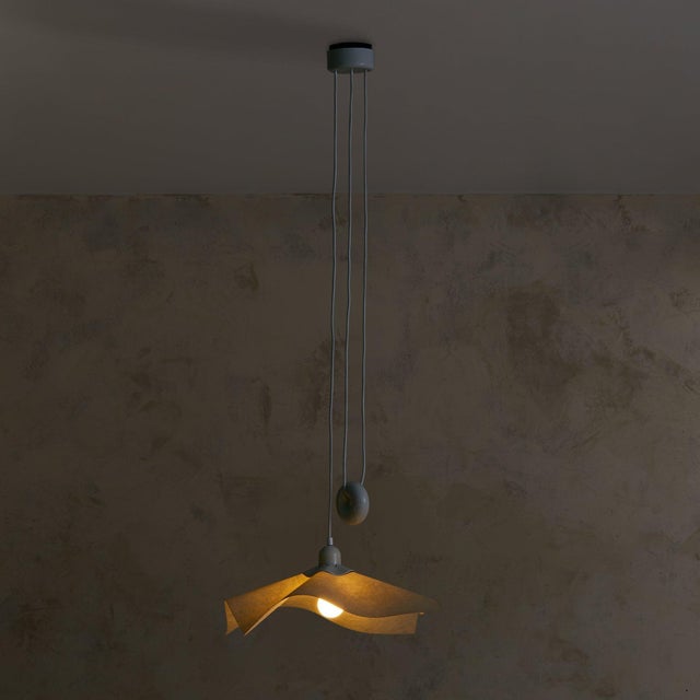 The Area 50 pendant light, designed by Mario Bellini, is a rare and iconic piece produced by Artemide in 1976. The resin...