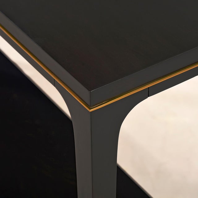 Featuring a smooth top and a sculpted apron adorned with a sleek brass accent. Made from Acacia to ensure durability and a...