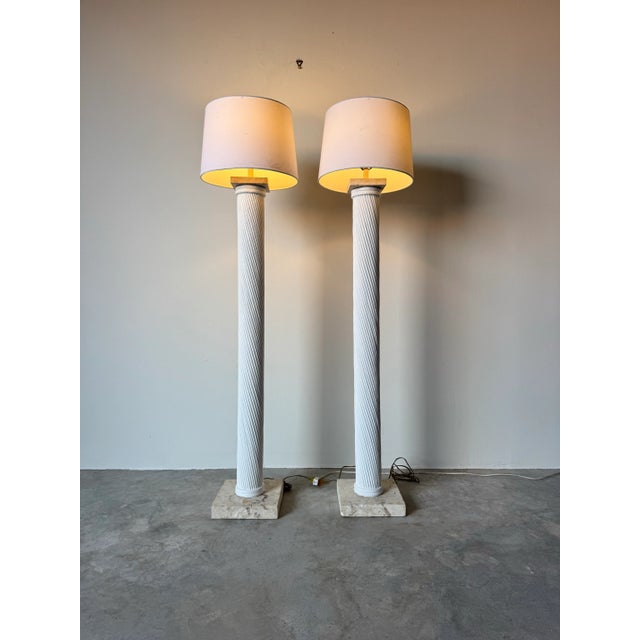 Elevate your interior with this striking pair of 1980s vintage faux pencil reed plaster floor lamps, featuring a...