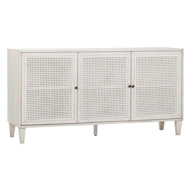 White wash finish acacia wood frame sideboard with rattan panels on three doors. Perfect for a coastal contemporary...