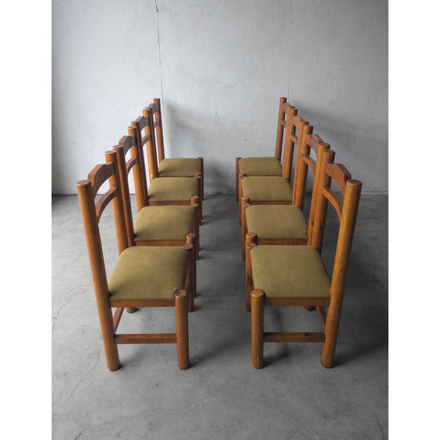 This is a beautiful large scale and chunky set of 8 pine dining chairs. The warm pine wood and clean lines give them a...