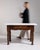 A robust butcher-style table featuring a solid base and marble top, combining practicality with refined material contrast....