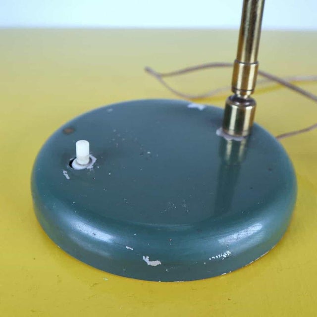 This vintage table lamp features an elegant and functional design that recalls classic industrial style. Crafted with a...