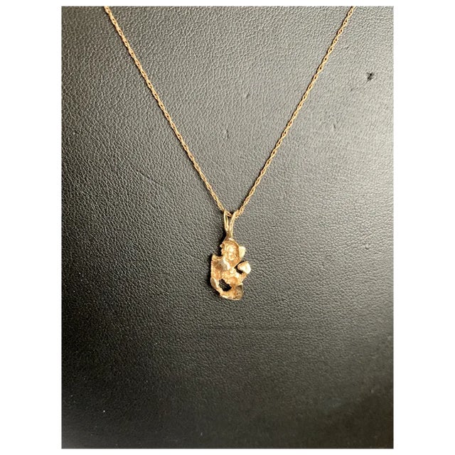 14k gold nugget pendant from the 70s. Pendant features a large built in bail that will accomodate various sizes of chains....