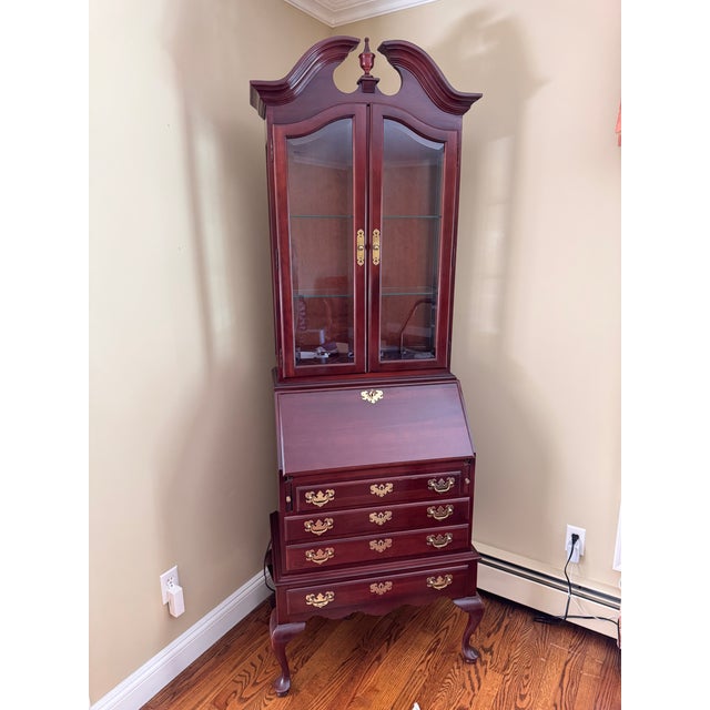 Part of the Georgian court collection in Chippendale style. The upper hutch has beveled glass doors, adjustable interior...