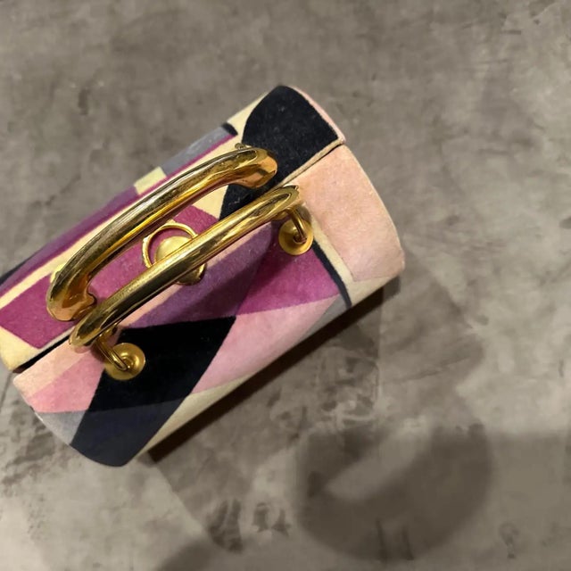 This is a stunning example of 1960s haute couture fashion: a velvet and brass minaudière bag by the iconic Italian...