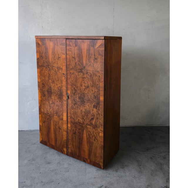 This Art Deco Walnut Cabinet with Bookmatched Burl Veneer is exceptional. It is distinguished by its striking bookmatched...