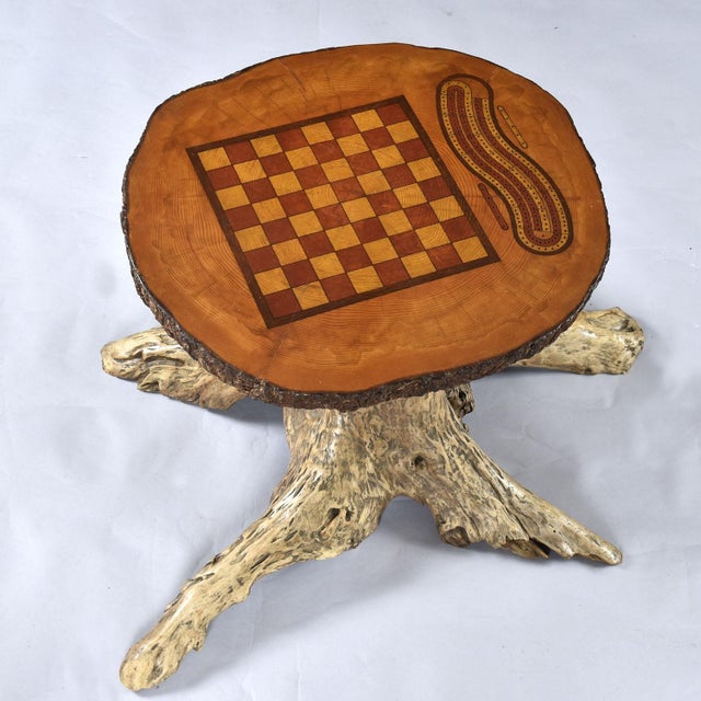 Hand made live edge chess and cribbage gaming table on a finished tree stump. This incredible work of art comes complete...