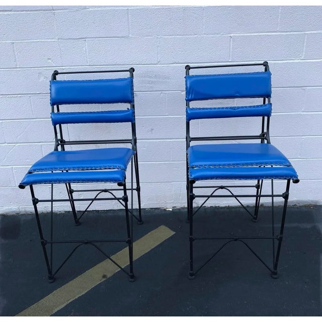Pair of Vintage mid century Ilana Goor style counter height stools made of blackened wrought iron and blue leatherette. A...