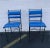 Pair of Vintage mid century Ilana Goor style counter height stools made of blackened wrought iron and blue leatherette. A...