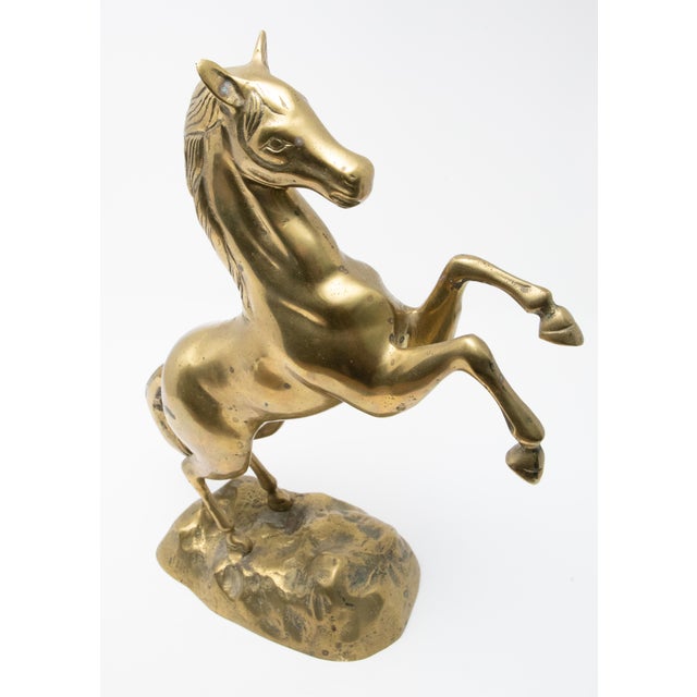 Beautiful sculpture of a raring horse out of brass. Starting on the base the two hind legs stand on ground with engraving...