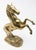 Beautiful sculpture of a raring horse out of brass. Starting on the base the two hind legs stand on ground with engraving...