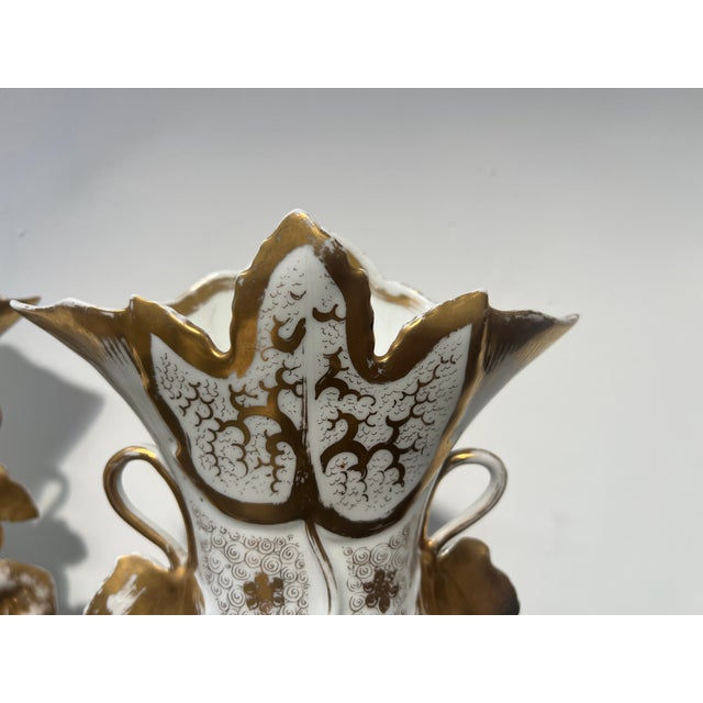 Pair of porcelain vases with gilt highlights Front with floral decoration within a cartouche Back with floral decoration...