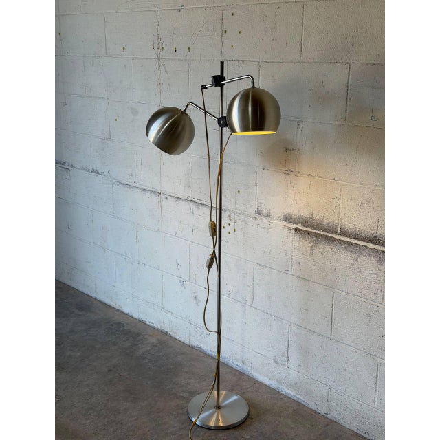 This adjustable dual-globe floor lamp delivers sleek task lighting with an articulating frame. Its slender silhouette...