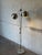 This adjustable dual-globe floor lamp delivers sleek task lighting with an articulating frame. Its slender silhouette...