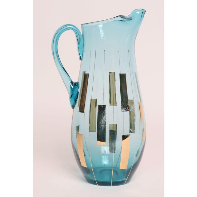 Vintage Hungarian hand-blown light blue crystal glass pitcher with geometric hand-applied gold accents and dense,...
