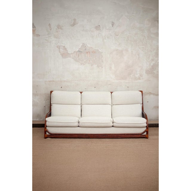 Bamboo sofa and armchair set – 1970s. Set composed of a sofa and two armchairs in bent bamboo with rush bindings. Complete...