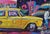 Slightly textured painting painted with vibrant oil represents old time yellow taxi cab standing on the street. Graffiti...