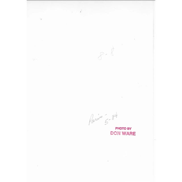 1984 black and white photo by California photographer Don Ware (1921-2006) of posters on a Parisian street wall. Titled,...