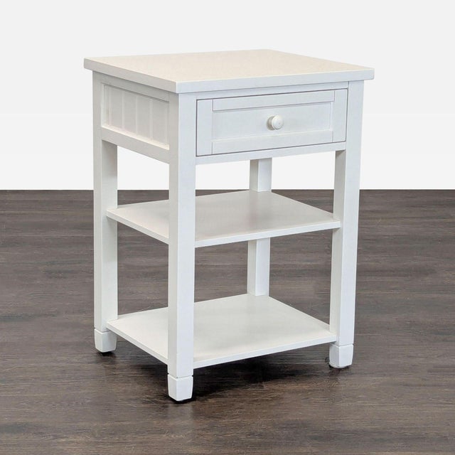 The nightstand features a drawer, fixed shelf and open shelves. It is crafted of solid pine with a hand-applied finish....
