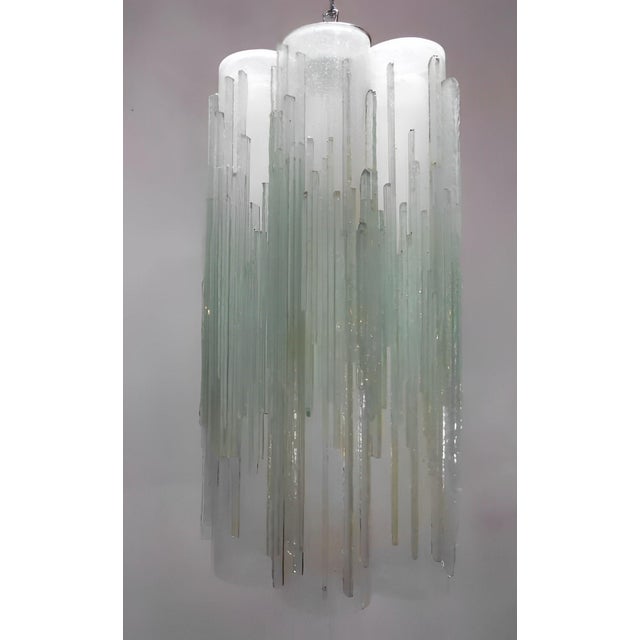 Striking vintage Italian pendant light featuring clear frosted Murano glass tubes, hand-blown with a distinctive icicle-...